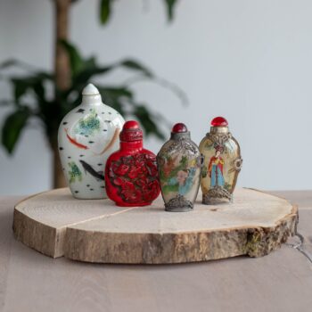Vintage Chinese snuff bottles on tree trunk tray